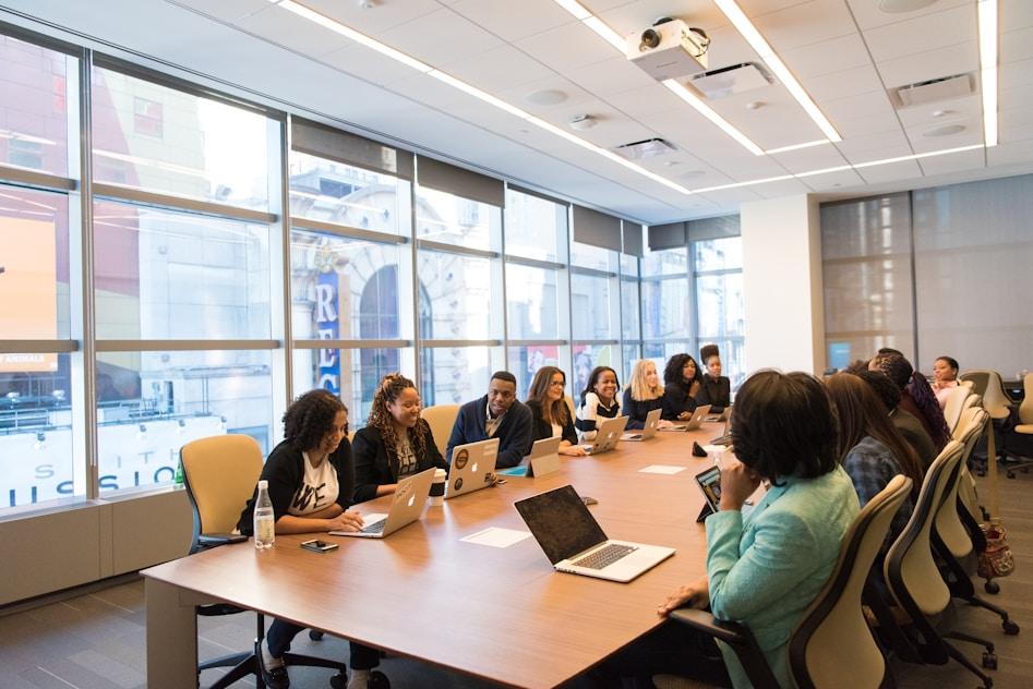 Delegates seated around a table at a conference